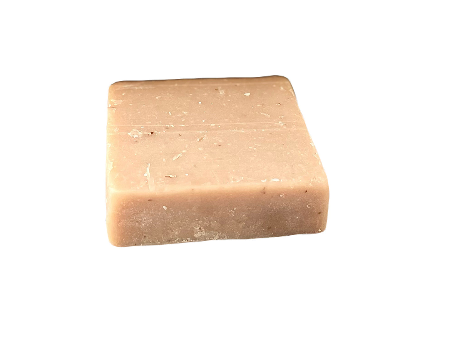 A beige oatmeal soap bar with visible specks of ground oats.