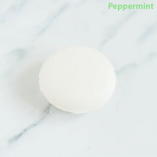 Peppermint shampoo bar on a marbled counter top