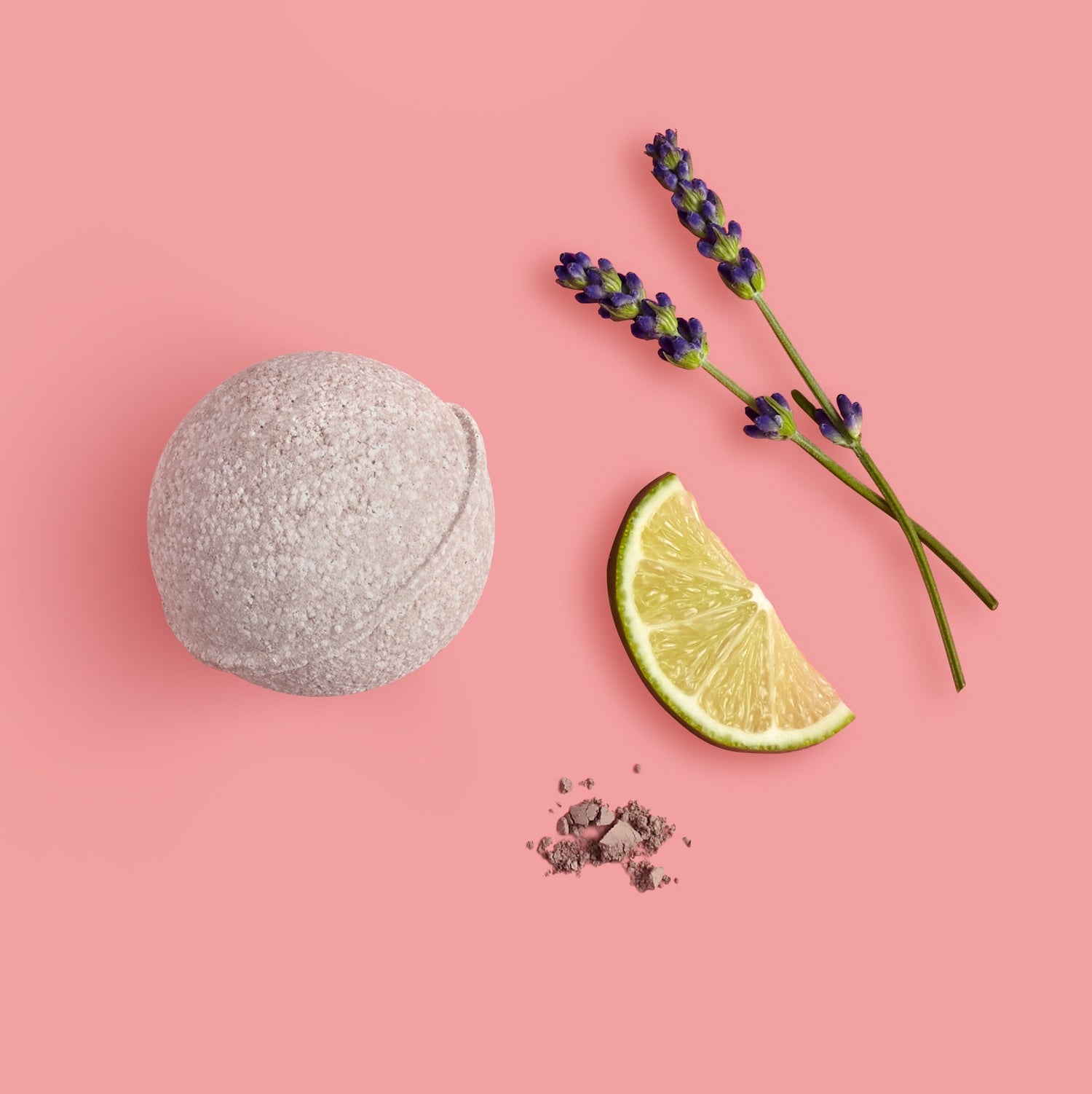 natural bath bomb next to lime slice and flower