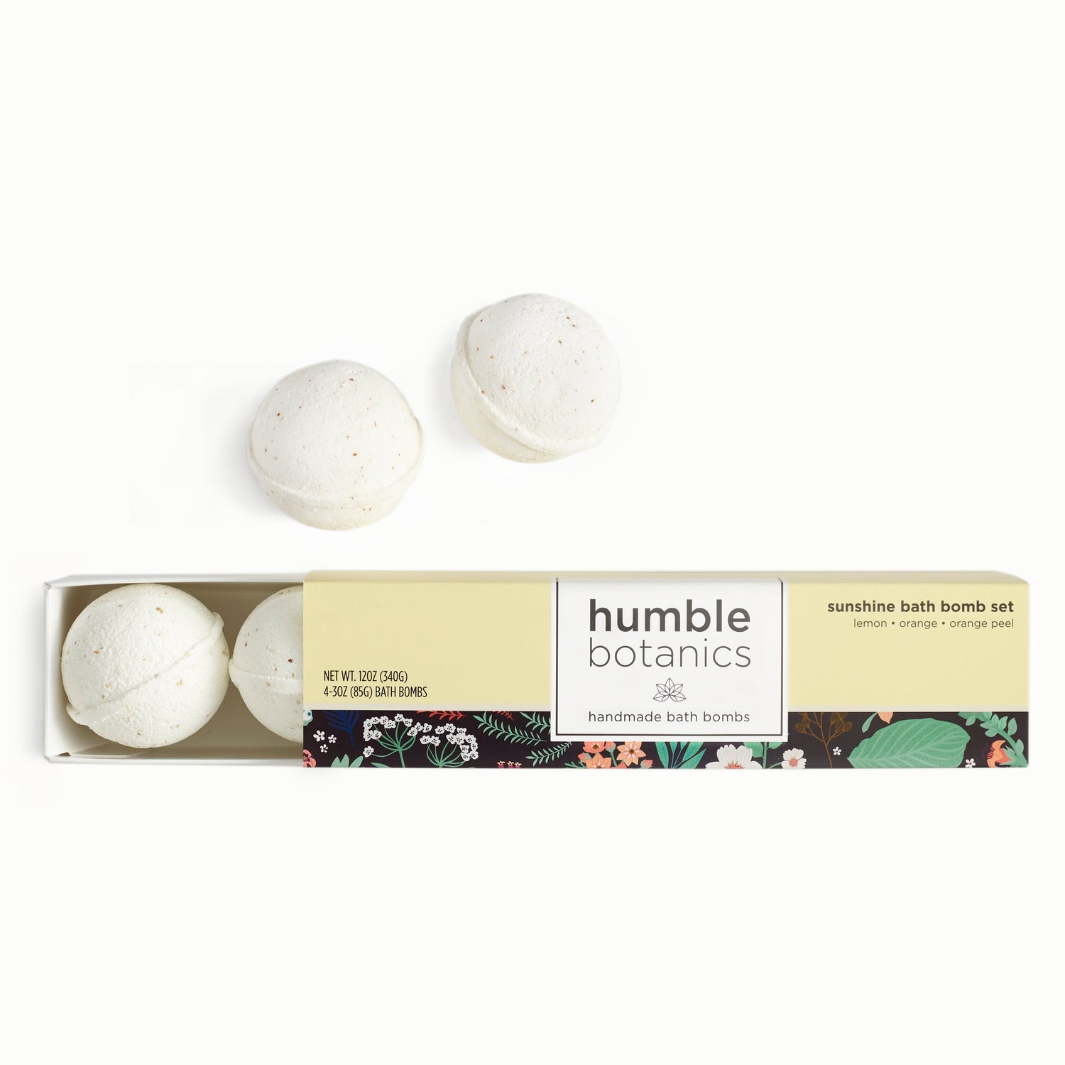 Relaxing bath bomb gift set with three handmade white bath bombs in a botanical-themed yellow box.
