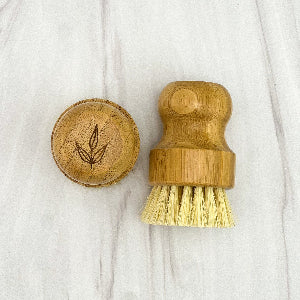 Bamboo dish brush with bristles on a white background