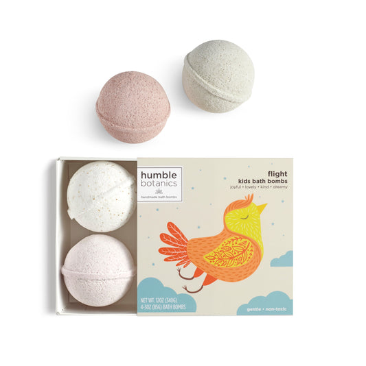 A colorful bath bomb for kids gift set featuring four 3oz fizzers and a whimsical box with a bird illustration, handmade by Humble Botanics.