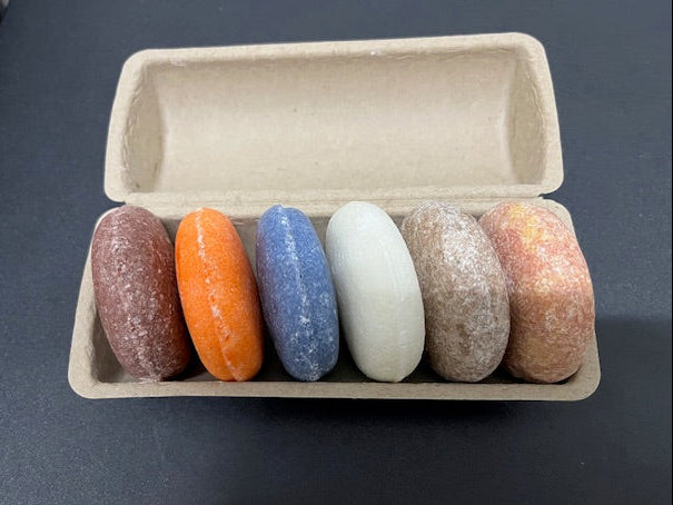 Close-up side view of colorful variety soap bars showing texture and thick cut.