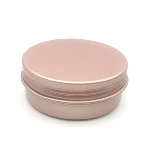 A rose gold colored shampoo bar tin with a screw-top lid, suitable for storing shampoo bars or other bath products.