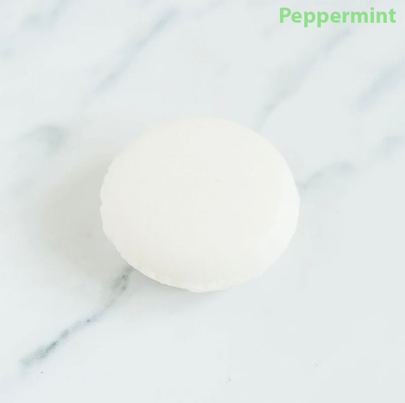 Peppermint shampoo bar on a marbled counter top